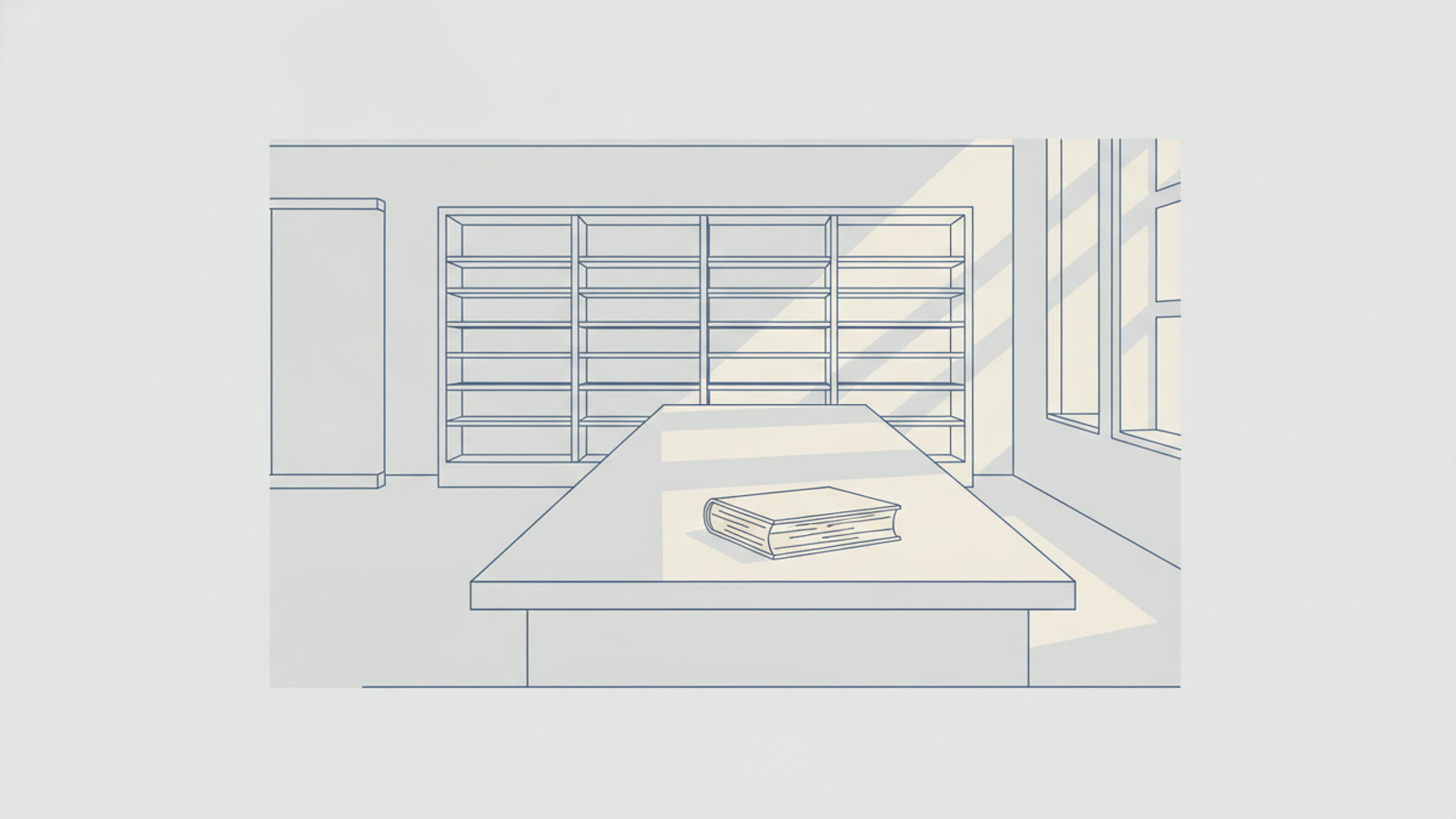 図書館の机に、閉じた古い本が一冊